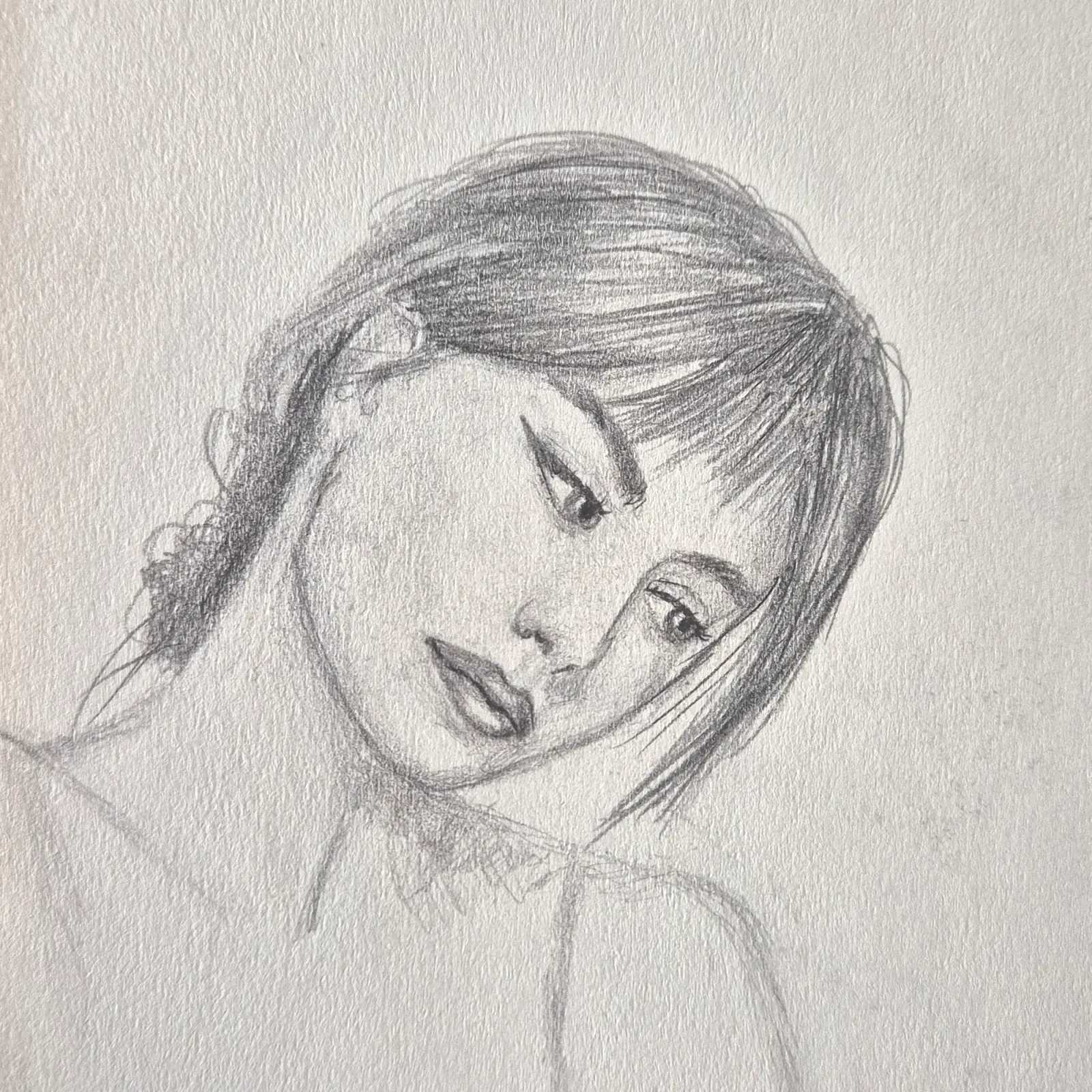Portrait of a woman with her head tilted, eyes lowered.