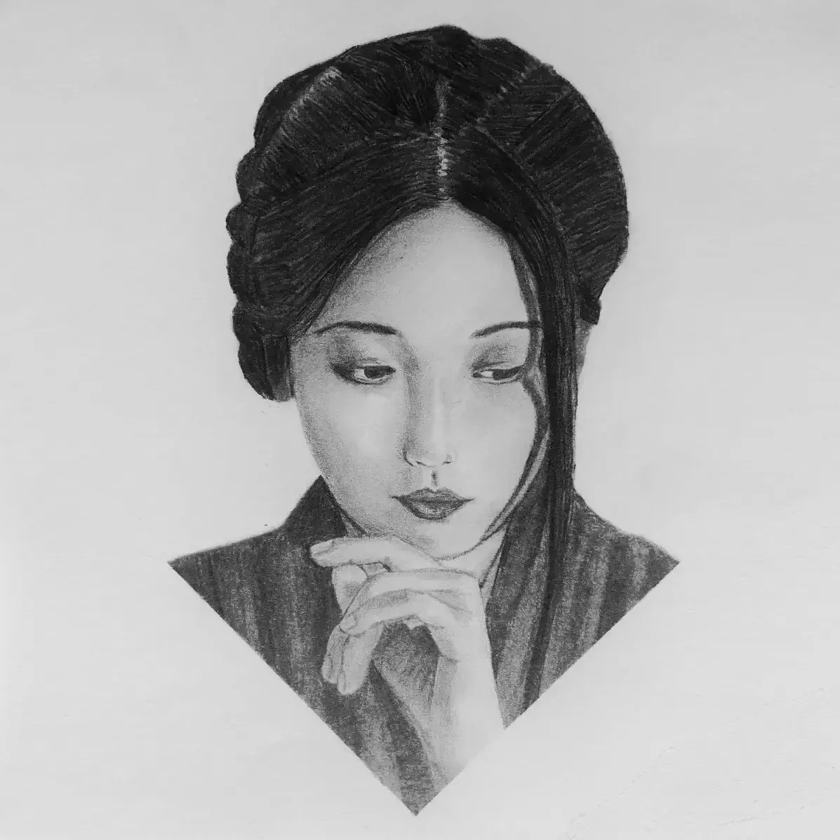Portrait of a woman resting her chin on her hand.