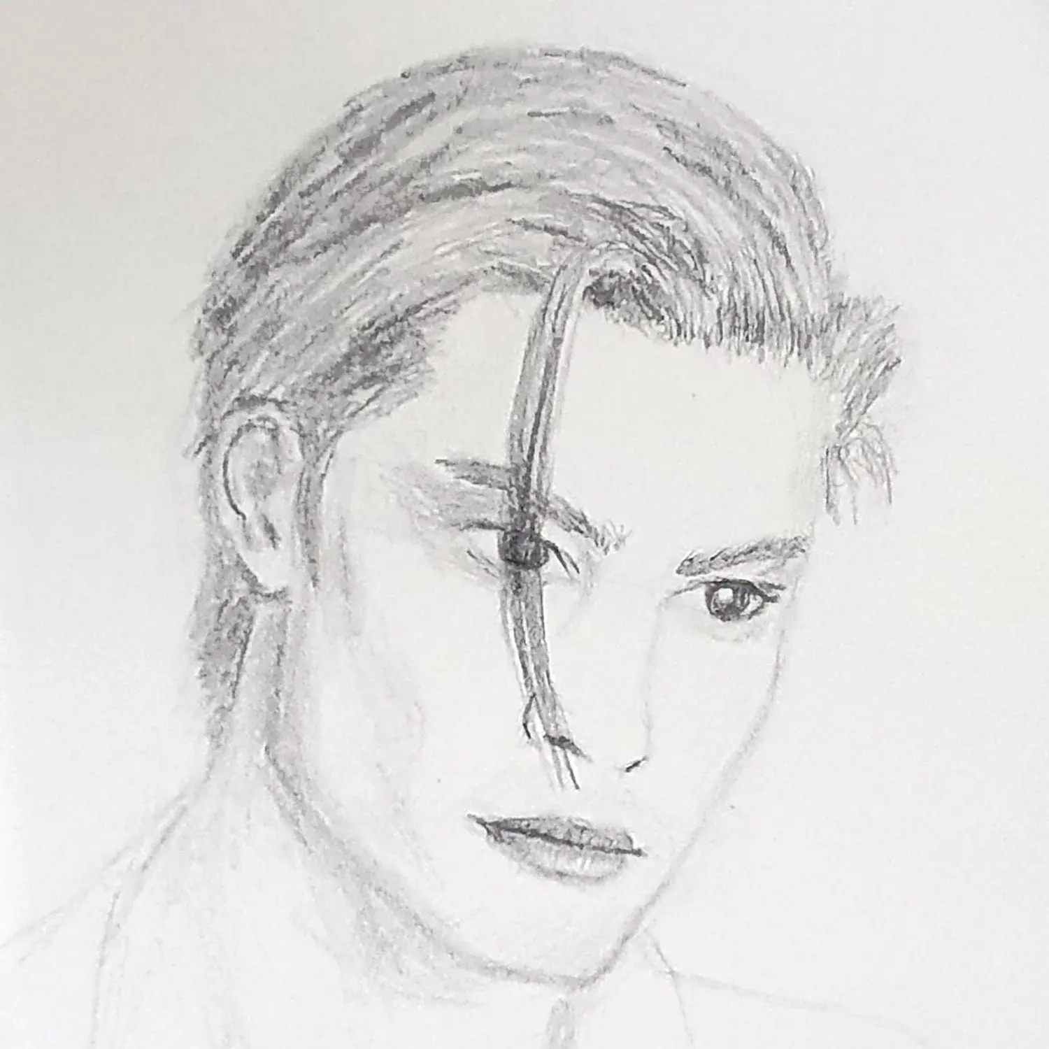 Portrait of a young man with hair swept back.