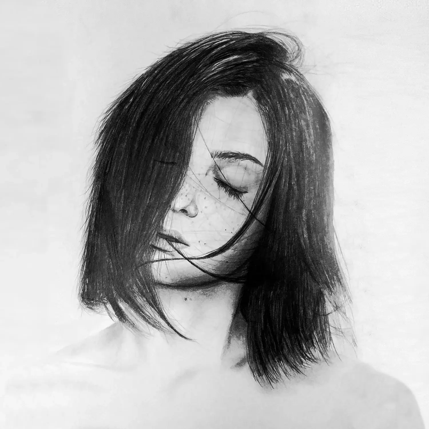 Charcoal portrait, hair blown across a closed-eyed face.